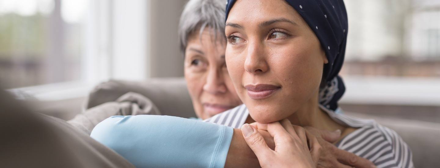 A mother embraces her daughter who is a cancer patient